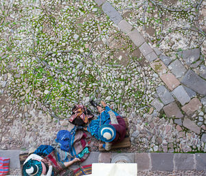 Directly above shot of female workers knitting wool