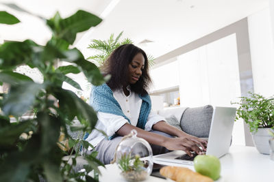 Freelancer working on laptop at home office