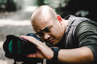 Close-up of man photographing in city