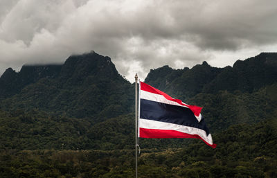 Low angle view of flag against mountain