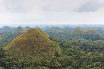 Scenic view of mountain range against cloudy sky