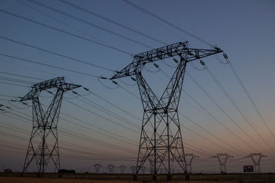 Low angle view of electricity pylon against sky