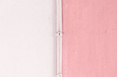 The core is between two color light pink and pink wall background. two side of wall.