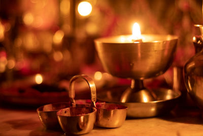 Close-up of illuminated tea light candles on table