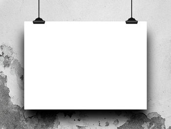 Close-up of blank paper hanging against wall