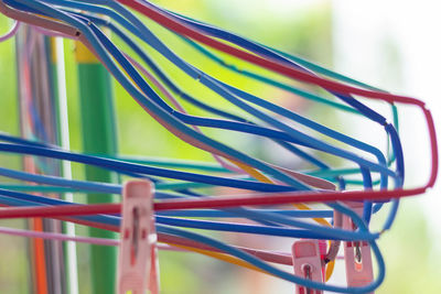 Close-up of multi colored coathangers on rack