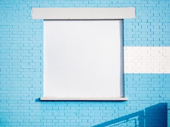 White window on blue wall