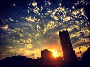 Low angle view of silhouette buildings against sky during sunset