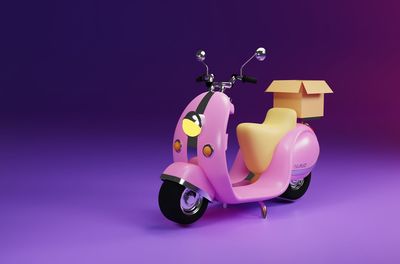 Close-up of toy car against pink background