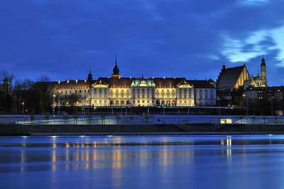 View of illuminated buildings against cloudy sky