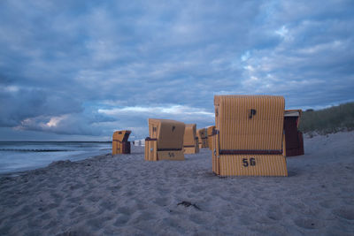 Lifeguard hut on beach against sky