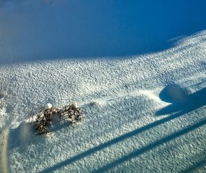High angle view of snow on beach against sky