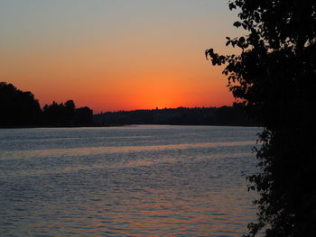 Scenic view of sea against orange sky