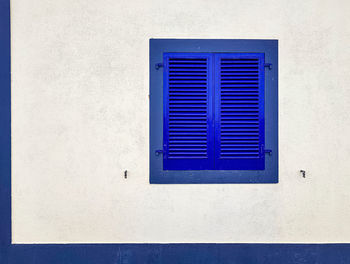 Close-up of blue window on wall