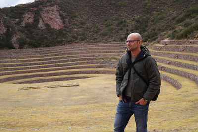 Man standing on steps against mountain