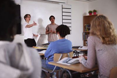 Teenage boys standing in classroom