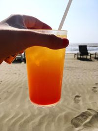 Close-up of beer on beach