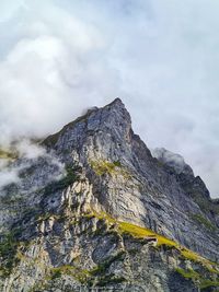 Low angle view of rocky mountains against sky