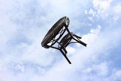 Low angle view of helicopter flying against sky