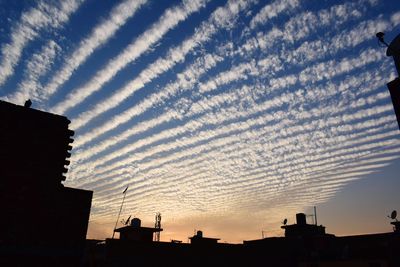 Low angle view of silhouette buildings against sky