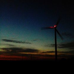 Low angle view of landscape against sky at sunset