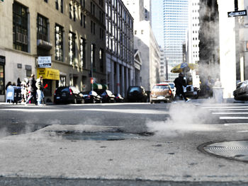 Steam from manhole on street in manhattan