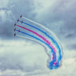 Low angle view of airshow against sky