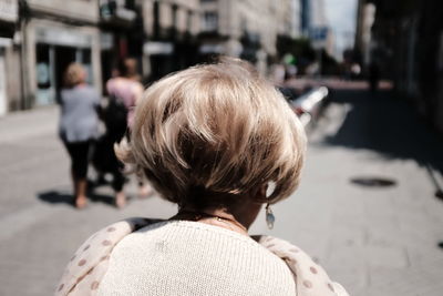 Rear view of woman in city street