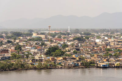 High angle view of townscape by sea against sky