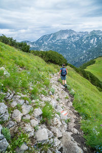 Woman hiking on alpine footpath in the austrian alps, loser mountain region, austria