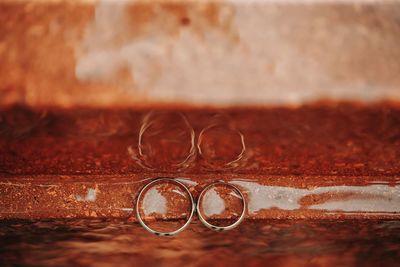 Close-up of wedding rings on table