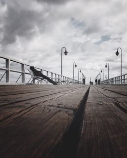 Footbridge over city against sky