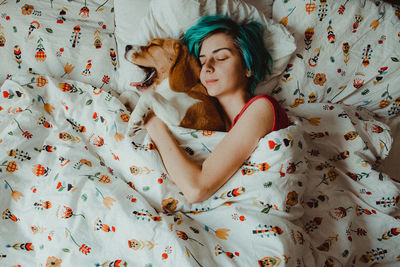 High angle view of dog sleeping on bed