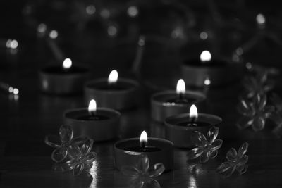 Close-up of lit candles on table