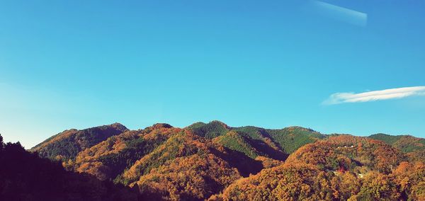 Low angle view of mountain against blue sky