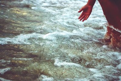 Low section of person enjoying at beach