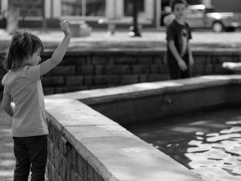 Rear view of boy standing outdoors