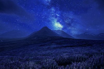 Scenic view of landscape against sky at night