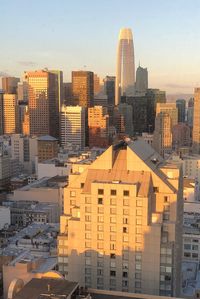 Buildings in city against sky during sunset