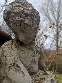 Close-up of statue against stone wall