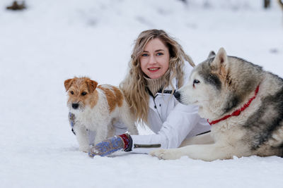 Young woman with dog in snow