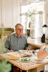 Mid adult man having food at table