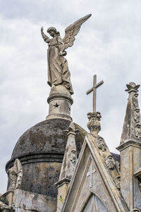 Low angle view of statue against cloudy sky