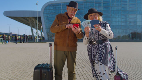 Senior couple standing at airport