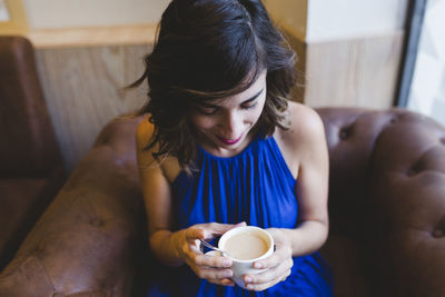 Young woman drinking coffee cup at home