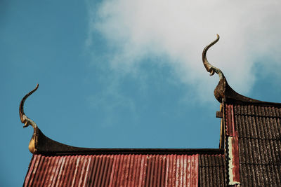 Low angle view of old building against cloudy sky