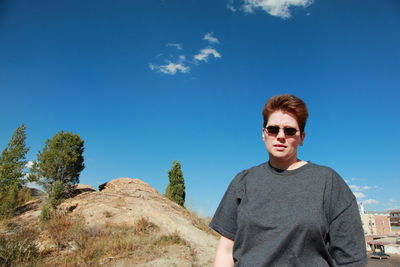Portrait of mid adult lesbian woman against blue sky