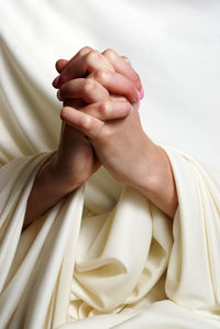 Close-up of woman with clasped hands praying