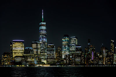 Illuminated buildings against sky at night