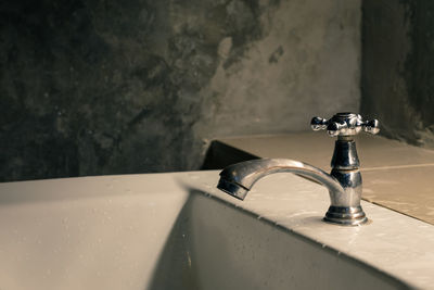 Close-up of faucet in bathroom